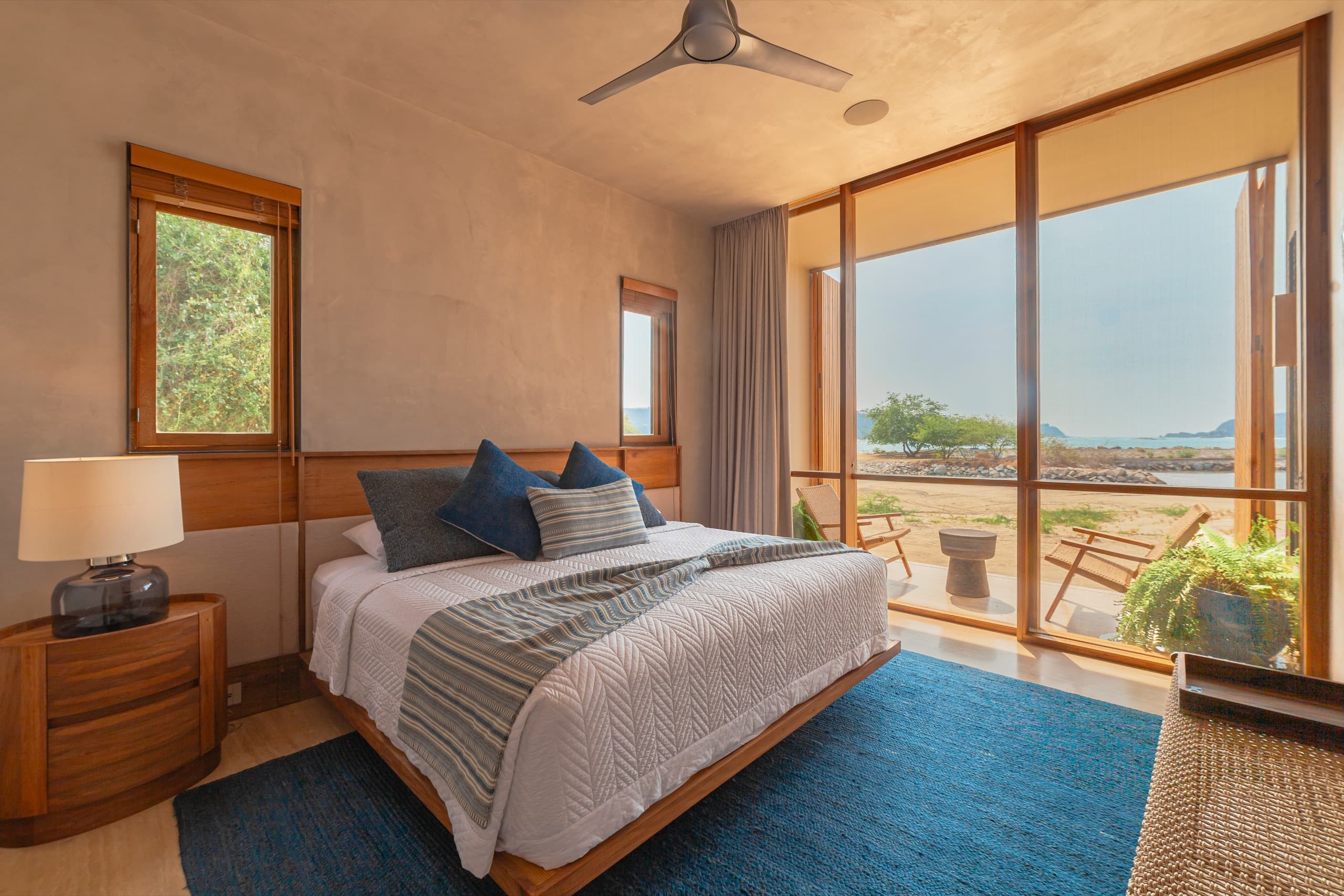 Ocean-view suite with a king bed and floor-to-ceiling windows
